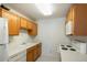 Functional kitchen featuring wooden cabinets, white appliances, and ample counter space at 13093 W Cedar Dr # 322, Lakewood, CO 80228