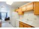 Well-lit kitchen featuring essential appliances, white countertops, and ample storage space at 13093 W Cedar Dr # 322, Lakewood, CO 80228