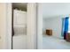 Convenient laundry area with stacked washer and dryer units near a bedroom at 13093 W Cedar Dr # 322, Lakewood, CO 80228
