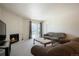Cozy living room with a fireplace, plush seating, and sliding door access to the outdoors at 13093 W Cedar Dr # 322, Lakewood, CO 80228