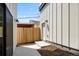 Small backyard with wooden fence, concrete patio, and storage shed at 1417 Zenobia St, Denver, CO 80204