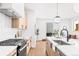 Modern kitchen with island, stainless steel appliances, and light wood cabinets at 1417 Zenobia St, Denver, CO 80204