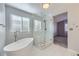 Bathroom with freestanding tub and glass enclosed shower at 13322 Marion St, Thornton, CO 80241