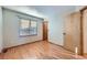 Bedroom with natural light, hardwood floors, and closet/ensuite access at 13322 Marion St, Thornton, CO 80241