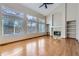 Spacious living room featuring hardwood floors, high ceilings, large windows, fireplace, and built-in shelving at 13322 Marion St, Thornton, CO 80241