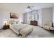 Staged main bedroom featuring neutral tones, a decorative window, and ample natural light at 13322 Marion St, Thornton, CO 80241