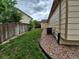 Side yard featuring a wooden fence and a gravel area, perfect for low-maintenance landscaping at 2239 S Truckee St, Aurora, CO 80013