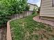 A grassy backyard with a brick retaining wall and a wooden fence, providing a private outdoor space at 2239 S Truckee St, Aurora, CO 80013