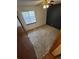 A bright bedroom featuring neutral carpet, a ceiling fan, and a large window for natural light at 2239 S Truckee St, Aurora, CO 80013