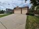 Spacious driveway leading to a two car garage, framed by blooming flower beds at 2239 S Truckee St, Aurora, CO 80013