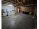 Large garage with shelving units, and a overhead door at 2239 S Truckee St, Aurora, CO 80013