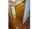 Hallway closet with wooden bi-fold doors next to a bathroom at 2239 S Truckee St, Aurora, CO 80013