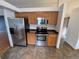 Well-lit kitchen with stainless steel appliances and wood cabinetry at 2239 S Truckee St, Aurora, CO 80013