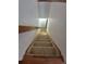 A carpeted stairway with wooden rails leads to the next level, ensuring safety and elegance at 2239 S Truckee St, Aurora, CO 80013