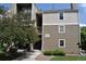 Attractive apartment building with two-tone siding, steps, and mature landscaping at 4896 S Dudley St # 8, Littleton, CO 80123