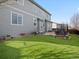 Home backyard showing patio, lounge area, and artificial lawn at 10730 Hillrose St, Parker, CO 80134