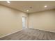 A finished basement features neutral carpet, lighting, and a doorway at 10730 Hillrose St, Parker, CO 80134