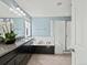 A bathroom features double sinks, a tub, and a separate shower area at 10730 Hillrose St, Parker, CO 80134