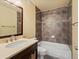 Bathroom with a vanity sink, toilet, and shower over tub at 10730 Hillrose St, Parker, CO 80134