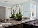 This bathroom has dual sinks, a granite countertop, and stylish fixtures at 10730 Hillrose St, Parker, CO 80134