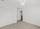 Bedroom with light gray carpet, white walls, and a closet with sliding doors at 10730 Hillrose St, Parker, CO 80134