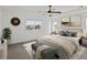 Cozy bedroom with neutral carpet, ceiling fan, bench, and bright window at 10730 Hillrose St, Parker, CO 80134