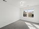 Bright bedroom featuring neutral carpet, white walls, and a double window for natural light at 10730 Hillrose St, Parker, CO 80134