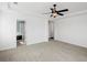 A spacious bedroom boasts fresh white walls, plush carpeting, and an elegant ceiling fan at 10730 Hillrose St, Parker, CO 80134