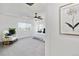 Bright bedroom featuring plush carpet, white walls, tray ceiling and a fan at 10730 Hillrose St, Parker, CO 80134