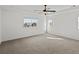 Spacious primary bedroom with a modern ceiling fan and plenty of natural light at 10730 Hillrose St, Parker, CO 80134