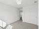 Cozy bedroom with light gray carpet, white walls and closet with sliding doors at 10730 Hillrose St, Parker, CO 80134