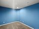 Carpeted bedroom featuring blue walls, white trim, and recessed lighting at 10730 Hillrose St, Parker, CO 80134