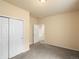 Bedroom with neutral carpeting, closet, and view into another room at 10730 Hillrose St, Parker, CO 80134