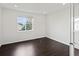 Minimalist bedroom features hardwood floors and a large window with plenty of natural light at 10730 Hillrose St, Parker, CO 80134