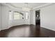 Bright dining room with hardwood floors, a modern chandelier, and large windows at 10730 Hillrose St, Parker, CO 80134