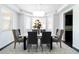 Bright dining room with bay window, modern chandelier, and stylish gray chairs around a large table at 10730 Hillrose St, Parker, CO 80134