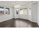Bright dining room featuring hardwood floors, large windows, and stylish modern chandelier at 10730 Hillrose St, Parker, CO 80134