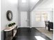 Elegant entryway boasting dark hardwood floors, a decorative mirror, and an open view to the dining area at 10730 Hillrose St, Parker, CO 80134