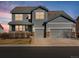 Two-story home showcasing a well-maintained lawn, three-car garage, and attractive landscaping at 10730 Hillrose St, Parker, CO 80134