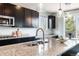 Close up of a granite countertop with stainless steel faucet in this modern kitchen at 10730 Hillrose St, Parker, CO 80134