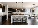 Modern kitchen featuring dark cabinetry, granite countertops, and a breakfast bar at 10730 Hillrose St, Parker, CO 80134