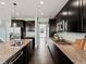 Galley kitchen boasts granite countertops, stainless steel appliances, and dark wood cabinetry at 10730 Hillrose St, Parker, CO 80134