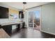 Bright eat-in kitchen features dark cabinets, granite counters, and sliding glass doors to patio at 10730 Hillrose St, Parker, CO 80134