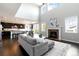 Bright, open-concept living room with fireplace and kitchen view in this home at 10730 Hillrose St, Parker, CO 80134