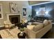 Inviting living room featuring a cozy fireplace, modern furnishings, and stylish decor at 10730 Hillrose St, Parker, CO 80134