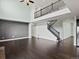 An open-concept living room featuring hardwood floors, high ceilings, a staircase, and a modern design at 10730 Hillrose St, Parker, CO 80134