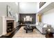 Spacious living room with fireplace, large windows, and a comfortable gray sofa with dark wood floors at 10730 Hillrose St, Parker, CO 80134