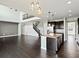 Open-concept living room featuring dark wood floors, a staircase, and abundant natural light at 10730 Hillrose St, Parker, CO 80134