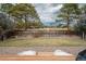 Serene backyard featuring a wood fence and mature trees, creating a private retreat at 4485 E Andover Ave, Castle Rock, CO 80104