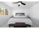 Bright bedroom featuring a large bed, ceiling fan, and natural light from the window at 4485 E Andover Ave, Castle Rock, CO 80104